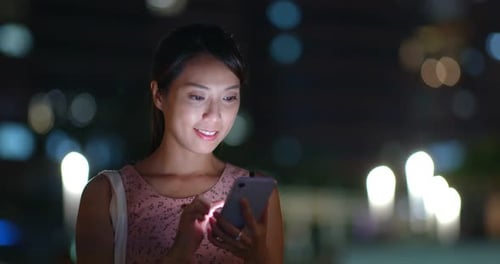 Woman use of mobile phone at night