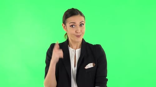 Indignant Woman Throwing Up Hands Expressing She Is Innocent, Twists His Finger at His Temple. Green