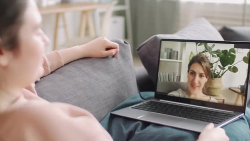 Two Women Chatting Via Laptop Video Call