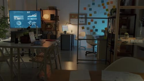 Zoomin of Empty Workplace in Contemporary Office with Modern Equipment at Night