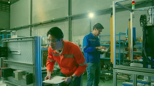 smart asian technical engineer working with assemble involved in the machine working design process