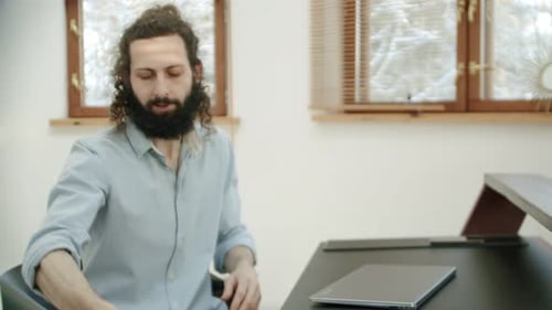After Finishing the Office Work or Video Call the Man Takes the Tool and Starts Playing It