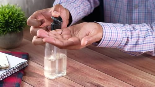Close Up of Young Man Hand Using Sanitizer Gel for Preventing Virus