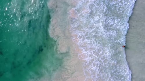 Beautiful Overhead Aerial of Waves Crashing at the Beach.