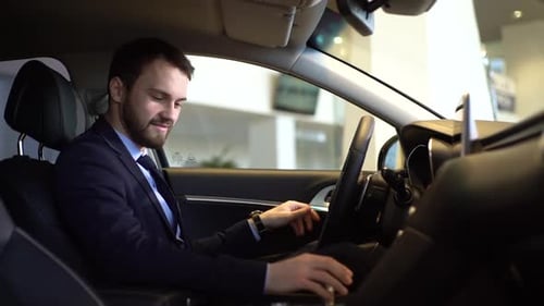 Man Examines Car Interior at Dealership