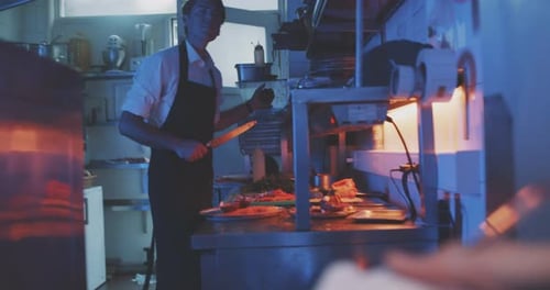 Waiter communicates to chef in professional kitchen