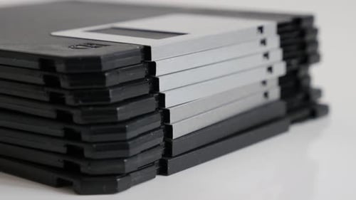 Stacked diskette data archives slow tilt 4K 2160p 30fps UHD footage - Close-up black floppy disc cl