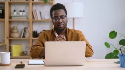 African Business Man Sit in Home Office Using Laptop Think About Idea and Plan for Work