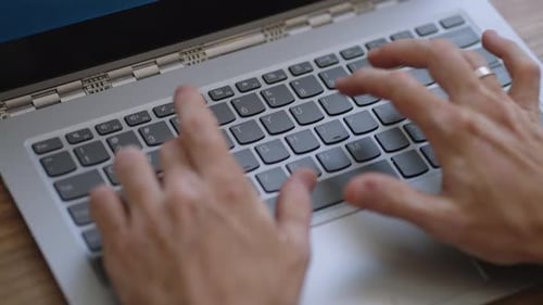 Adult Typing on Laptop Keyboard Close Up