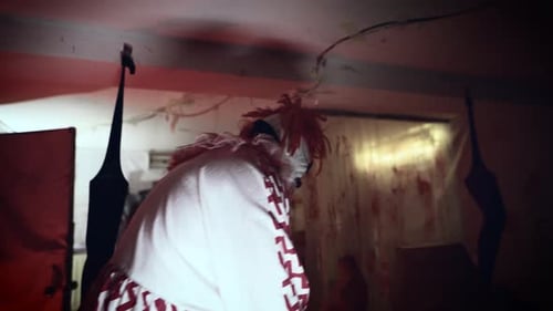 Scary Clown with Mask in Dark Room