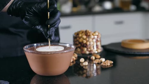 Cake Pop Being Dipped in Melted Chocolate