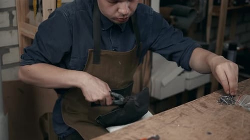 Man Crafting Shoe in Workshop