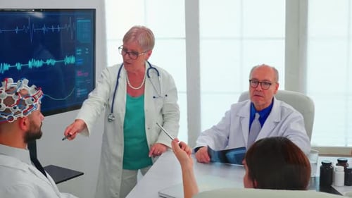 Scientist Doing Brain Analysis Using Headset with Sensors on Doctor