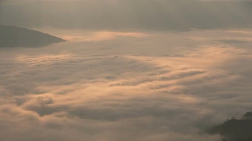 Golden Light Shines on Mountain Clouds
