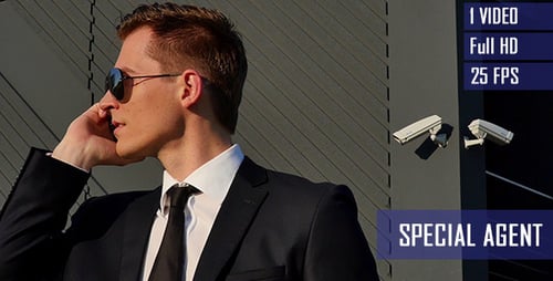 Man in Suit Talking on Phone by Building