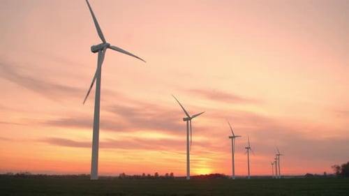 Large Wind Turbines in a Field with a Beautiful Sunset
