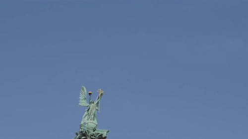 Hosok tere Archangel statue Budapest against blue sky slow tilt 4K 2160p UltraHD footage - Mill