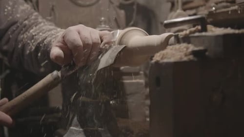 Woodworker Shapes Wood on Lathe in Close Up