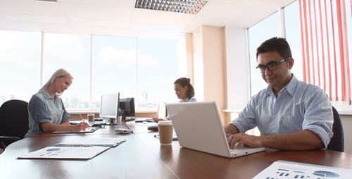 Team Working at Computers in Bright Modern Office