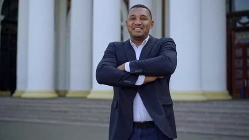 Middle Shot of Cheerful Successful Confident African American Businessman in Suit Crossing Hands