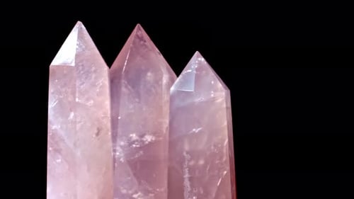 Three Rose Quartz and Crystal on Rotates on a Black Background