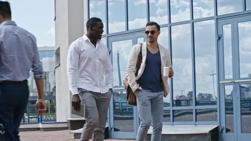 Two Stylish Men Walking and Talking near Office