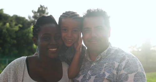 Happy multiracial family having playful time at park - Family love