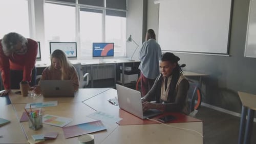 Young Hipster Colleagues Working in Modern Open Space Office