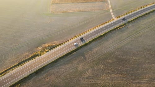 Aerial View of Intercity Road with Fast Driving Cars at Sunset