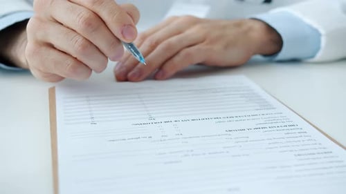 Hands Filling Out Medical History Form
