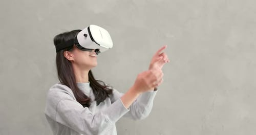 Young Woman Uses Virtual Reality Headset Indoors