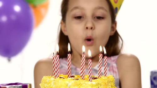 Girl Blowing Out Birthday Cake Candles