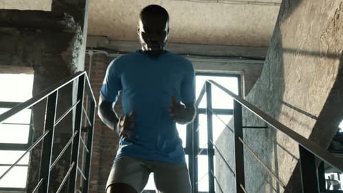 Athletic Man Running Up Stairs Indoors