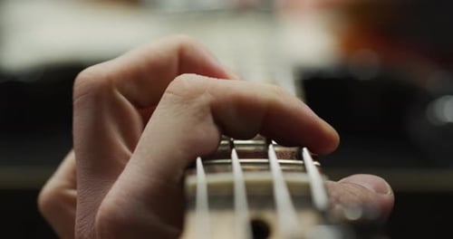Extreme close up of fingers playing the guitar