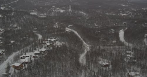Helicopter aerial shot rotating over green hills, day