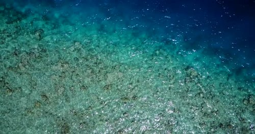 Tropical fly over tourism shot of a white sand paradise beach and aqua turquoise water background in