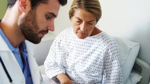 Doctor Explains Diagnosis to Patient Using Tablet