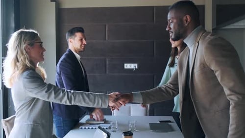 Four Colleagues Meet, Confer, and Shake Hands