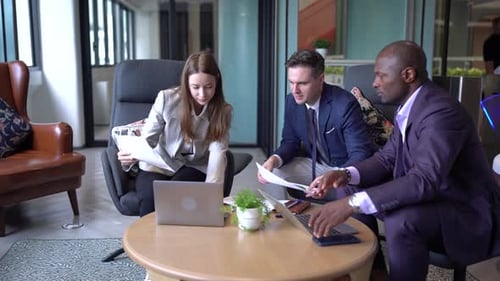 Diverse Business Team Meeting with Technology in Modern Office