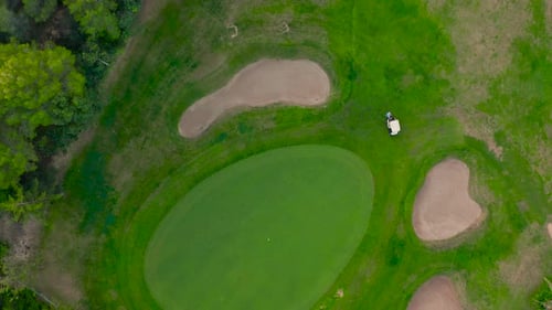 Aerial View. Golfer on a Vibrant Green Course.