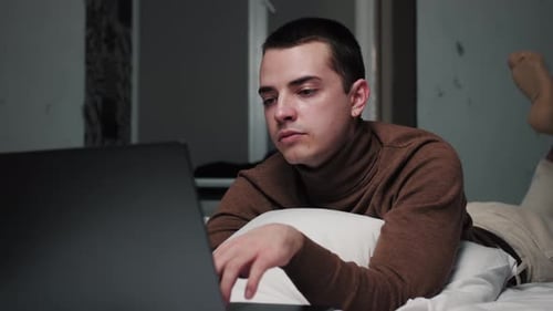 Young Adult Sleeping After Working on Laptop