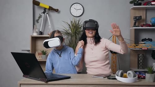 Mother and Child Using Virtual Reality Headsets Together