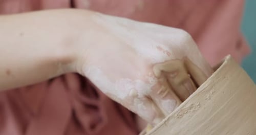 Artist Shaping Clay Vase with Wet Sponge