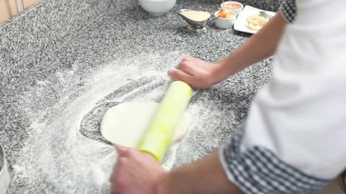 Cook Rolls Dough on Flour Covered Counter