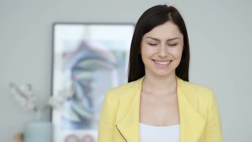 Smiling Woman Wearing a Yellow Jacket