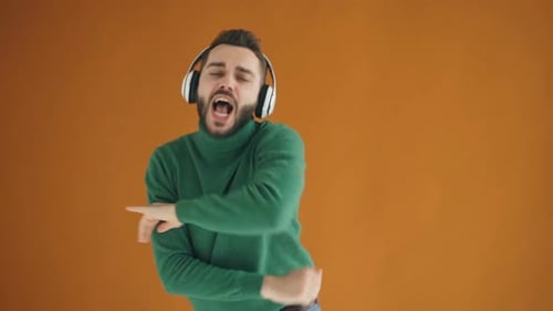 Slow Motion Portrait of Happy Student in Headphones Dancing Listening To Music