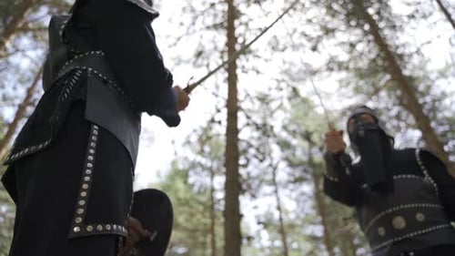 Figures in Hoods with Sword in Forest