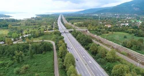 View of the stretching highway, mountains and lake.