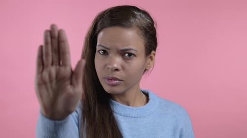 Mixed Race Woman Disapproving with NO Hand Sign Gesture
