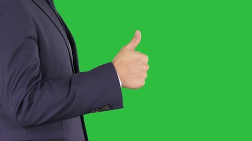 Businessman showing thumbs up on a Green Screen, Chroma Key.